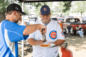 Retirement Planner Chawn Honkomp serving a hot dog at last year's tailgate at Principal Park in Des Moines
