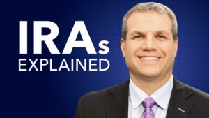 Man in suit and tie smiling with the words "IRAs Explained"