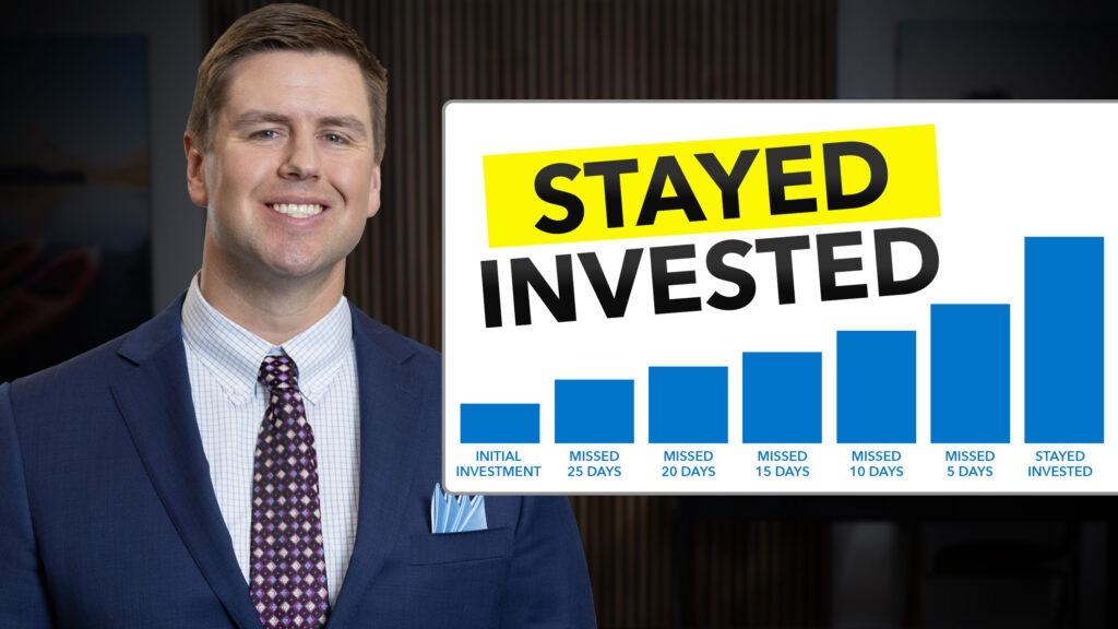 Man smiling standing next to a chart that says 'Stay Invested".