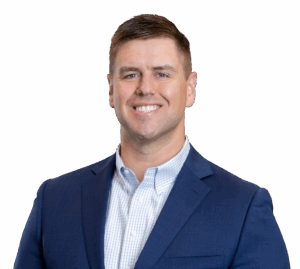 man smiling in a blue suit jacket no background