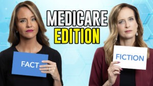 Two women looking holding up cards that read "Fact" and "Fiction"