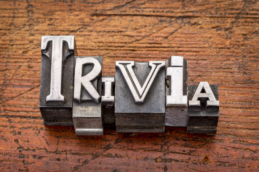 Wooden table with letterpress letters that spell out the word "trivia".