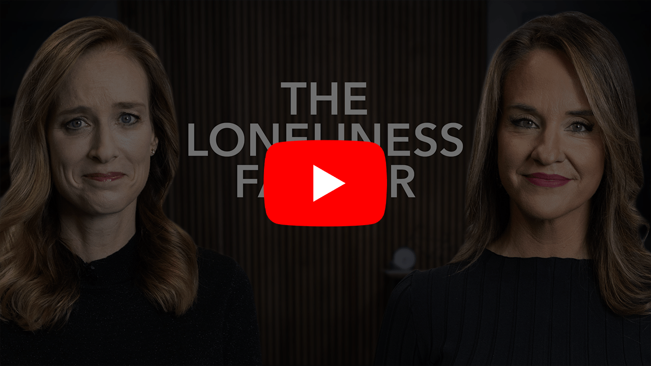 Two women standing in between the phrase, "The Loneliness Factor" with the YouTube play button overlaid.