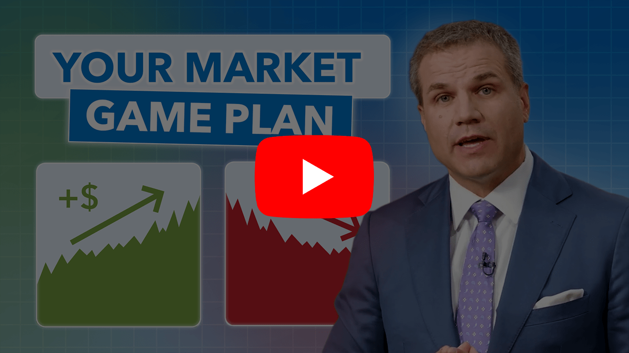 man standing in front of two market charts looking serious.