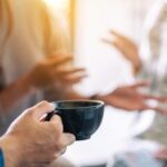 Close up image of people enjoyed talking and drinking coffee together